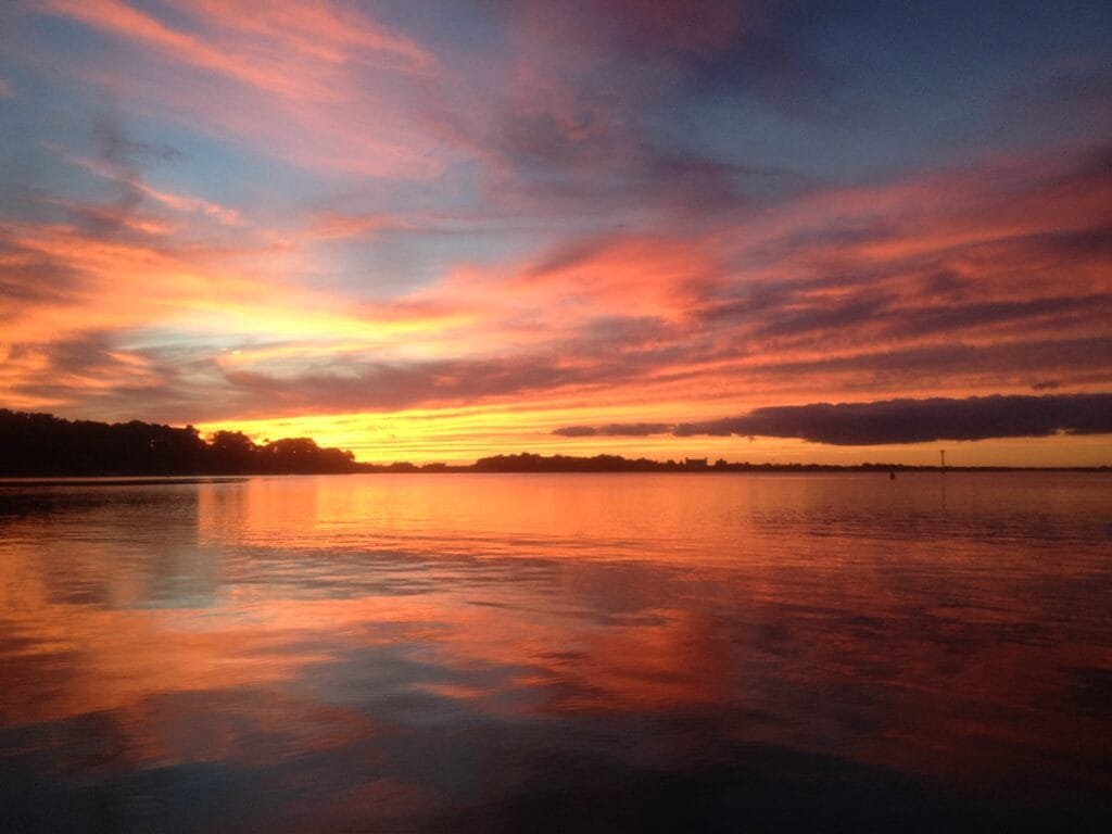 Sunset sail on Martha's Vineyard, the sky over Vineyard Haven glowing orange and pink