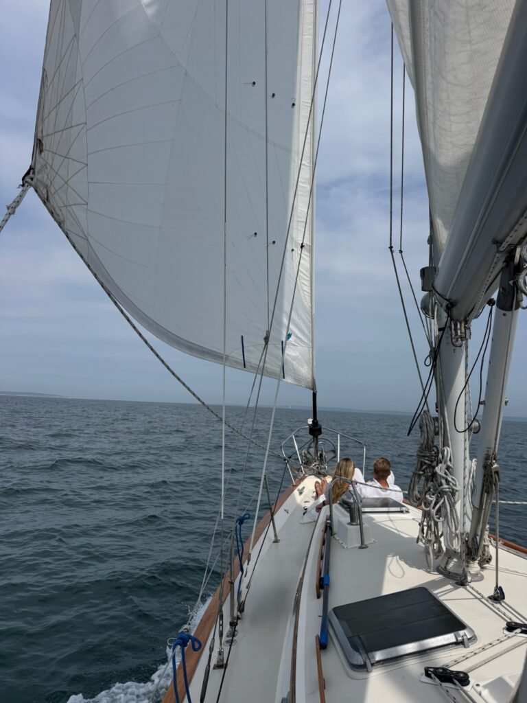Couple lounging on bow A couple sharing a romantic moment on the bow of a sailboat.