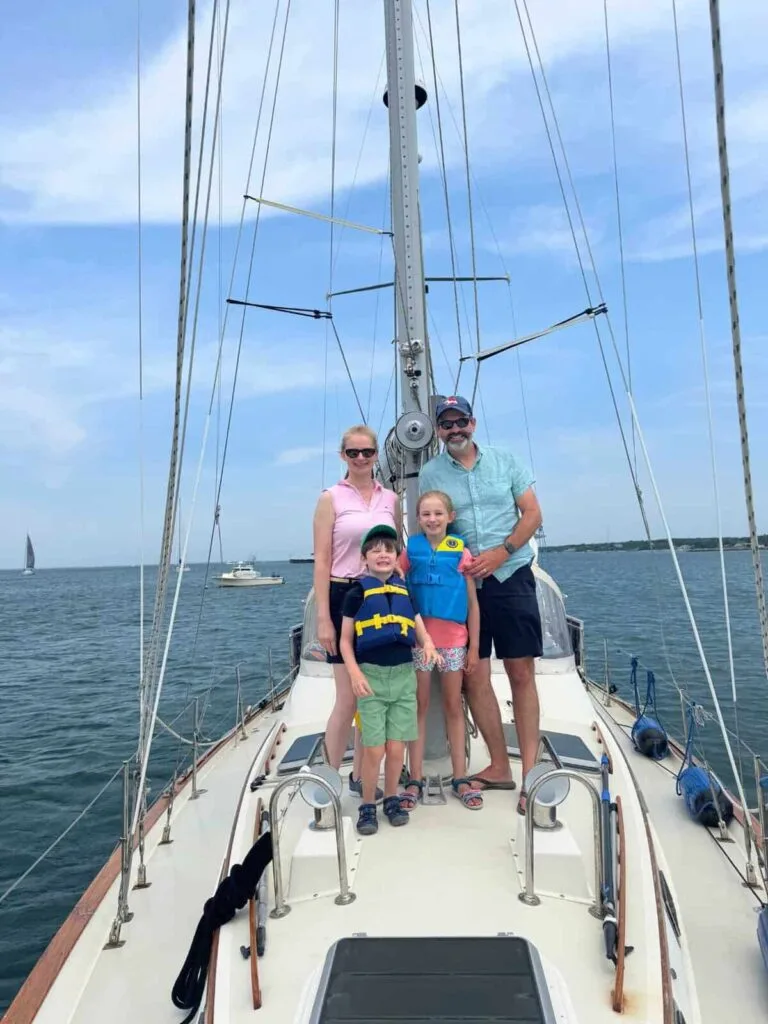 Family standing together on the bow of Our Passion during a Martha's Vineyard sailing charter