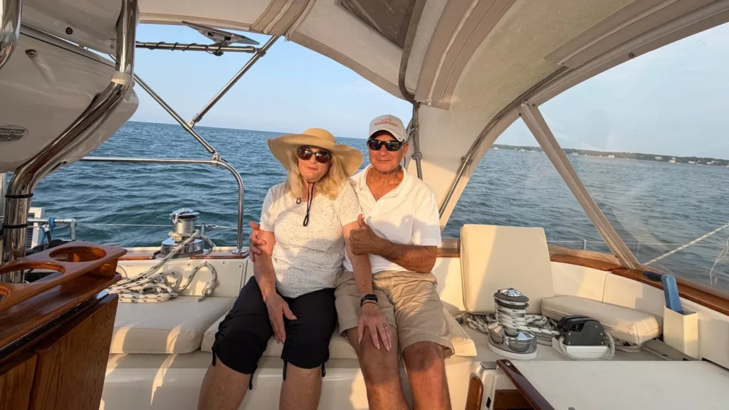 Private charter vs shared boat tour: a couple with the whole cockpit to themselves on a Martha's Vineyard sailing charter